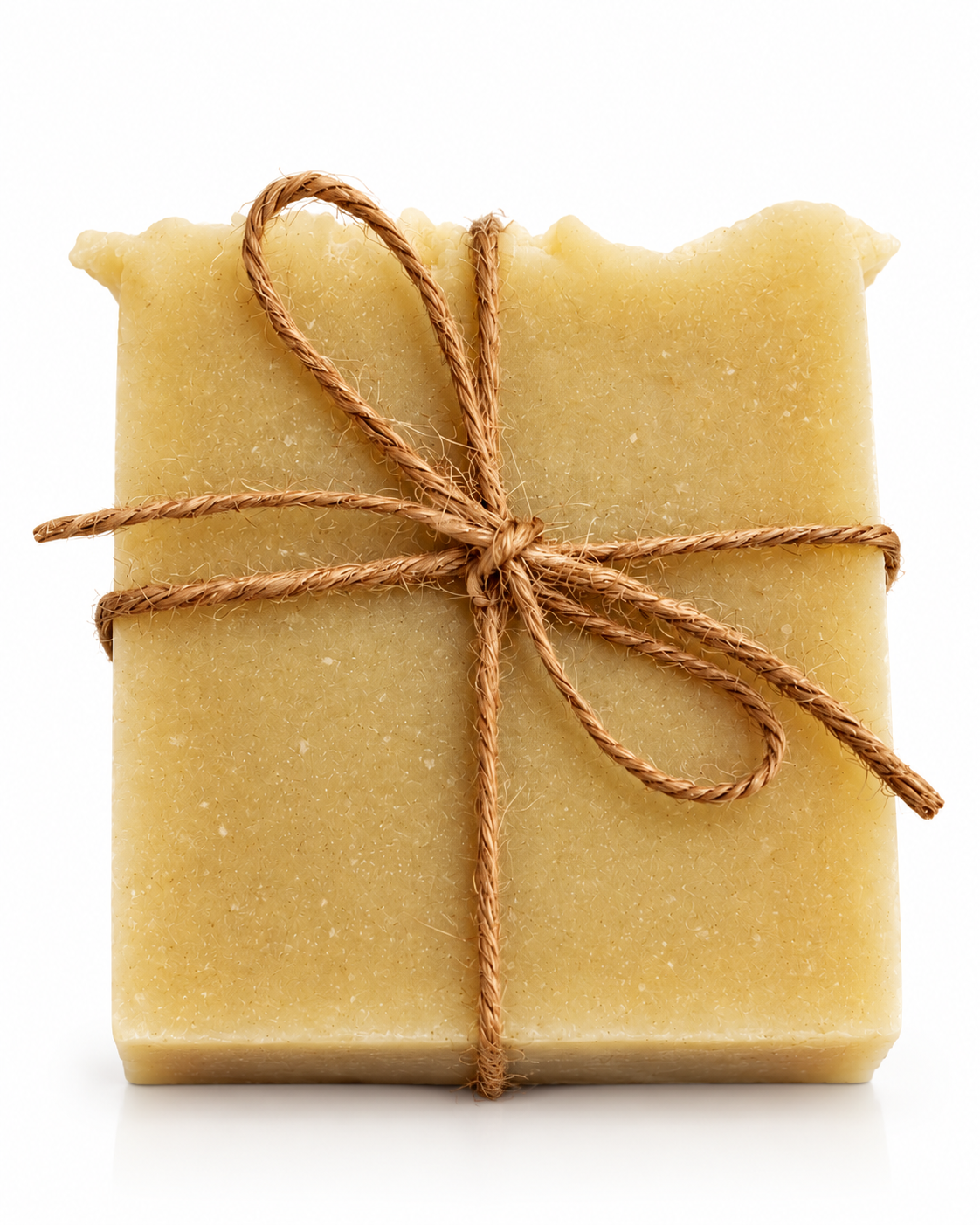Handmade Coconut and Kaolin Clay Soap Bar by Lytchett Bay Soaps, a natural beige soap wrapped in rustic twine on a white background.