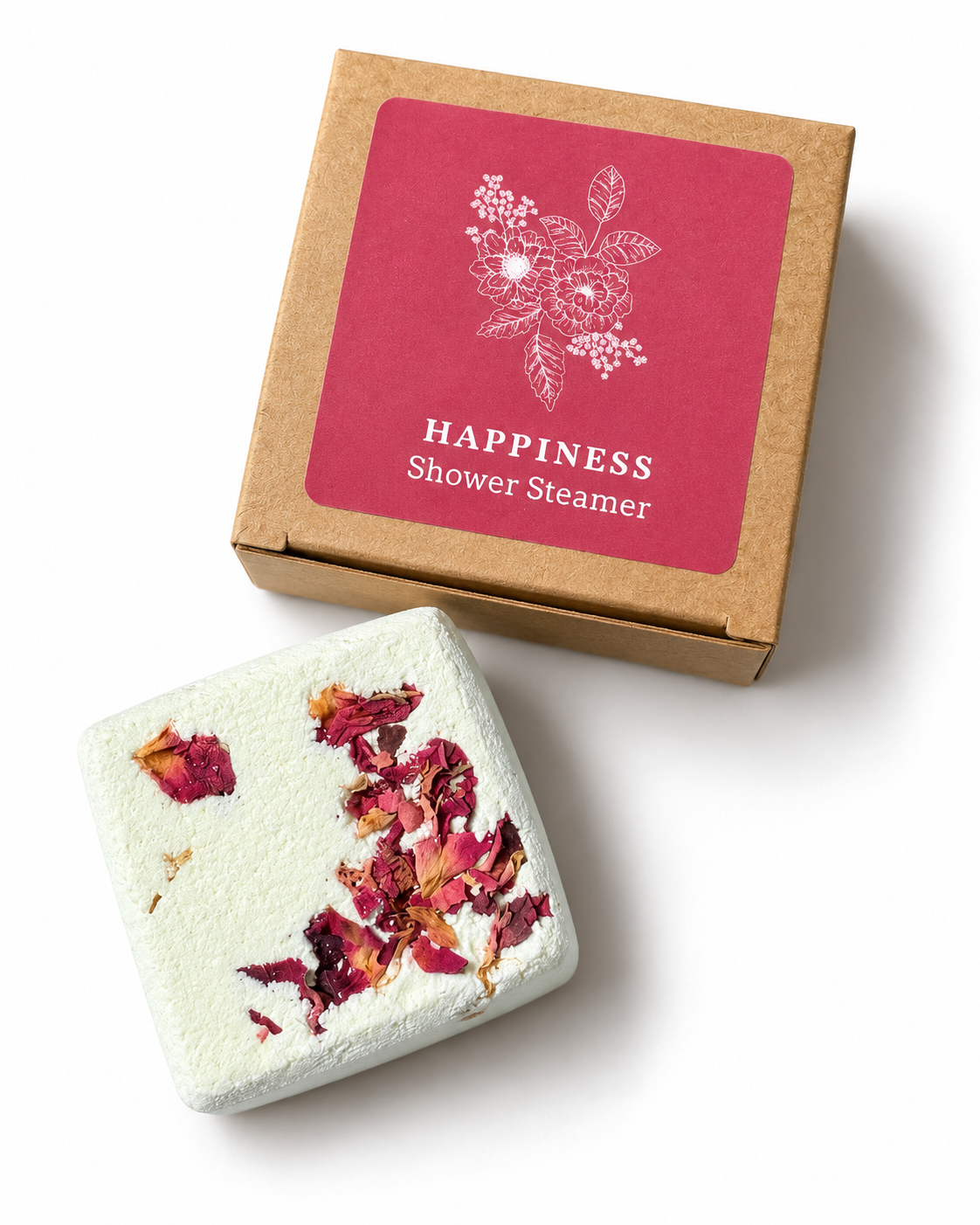Happiness aromatherapy shower steamer with orange, ylang ylang, patchouli and frankincense essential oils, decorated with dried rose petals and presented in a kraft gift box.