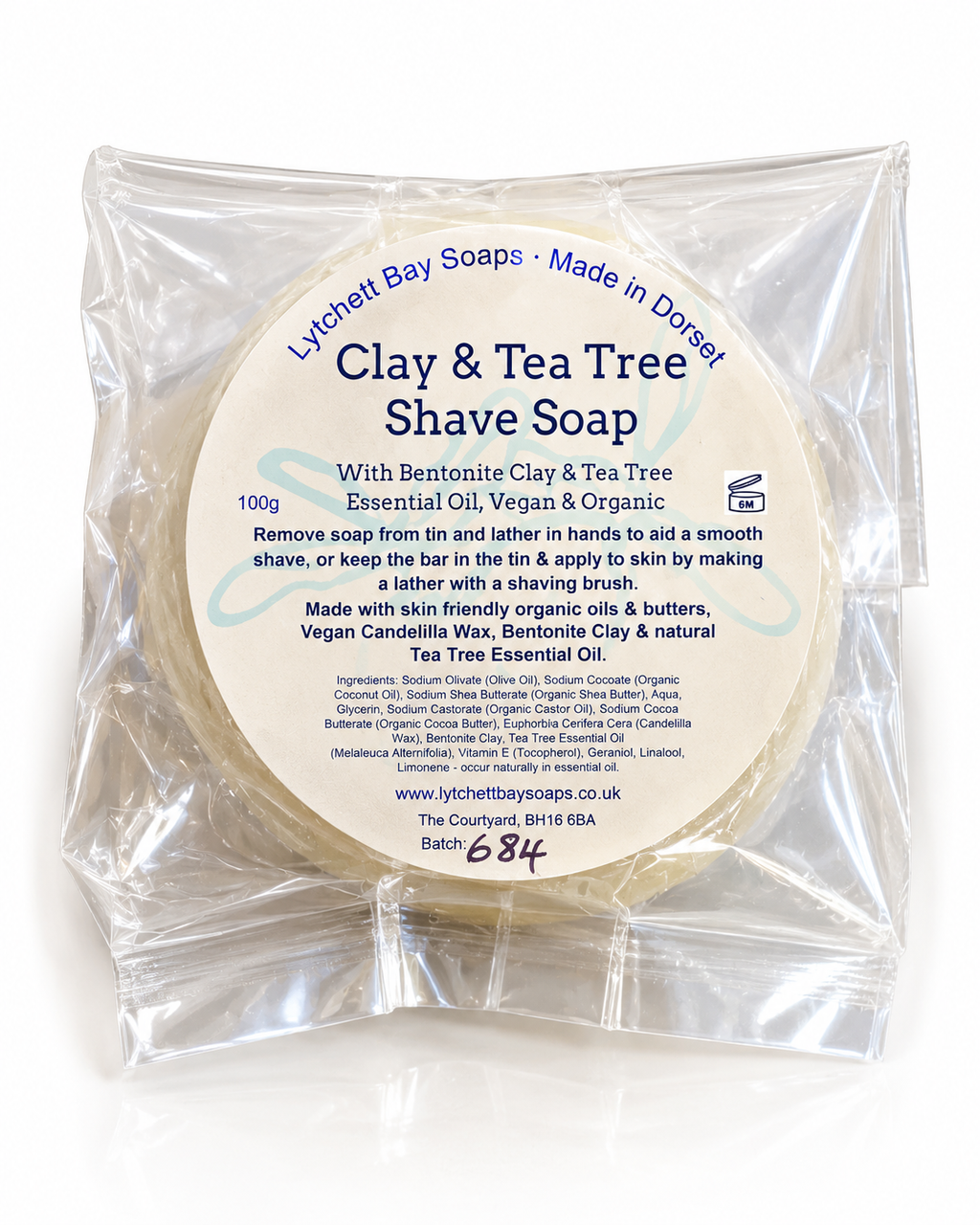 A 100g bar of Lytchett Bay Soaps Clay & Tea Tree Shave Soap in a clear plastic bag with a white paper label, photographed against a white background.